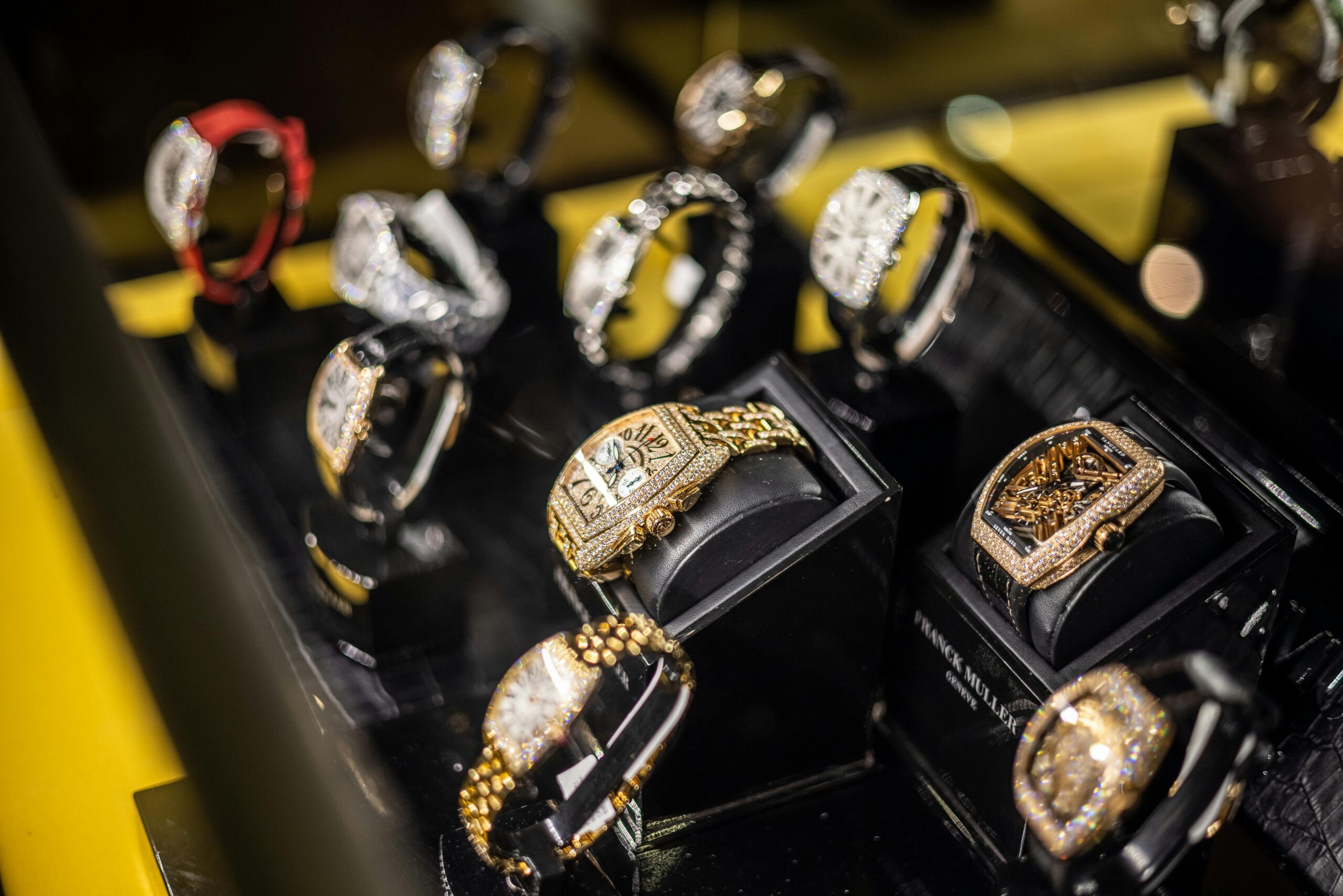 A captivating display of opulent gold and diamond watches in a high-end jewelry store setting.